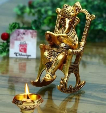 Golden Lord Ganesha Statue Sitting on a Rocking Chair and Reading Ramayan | Decorative Showpiece