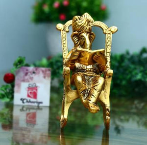 Golden Lord Ganesha Statue Sitting on a Rocking Chair and Reading Ramayan | Decorative Showpiece